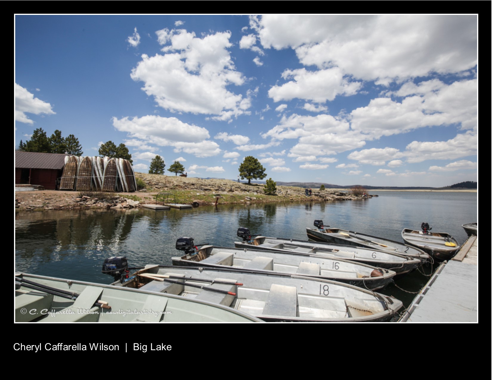 Boats docked at Big Lake with upended boats on shore